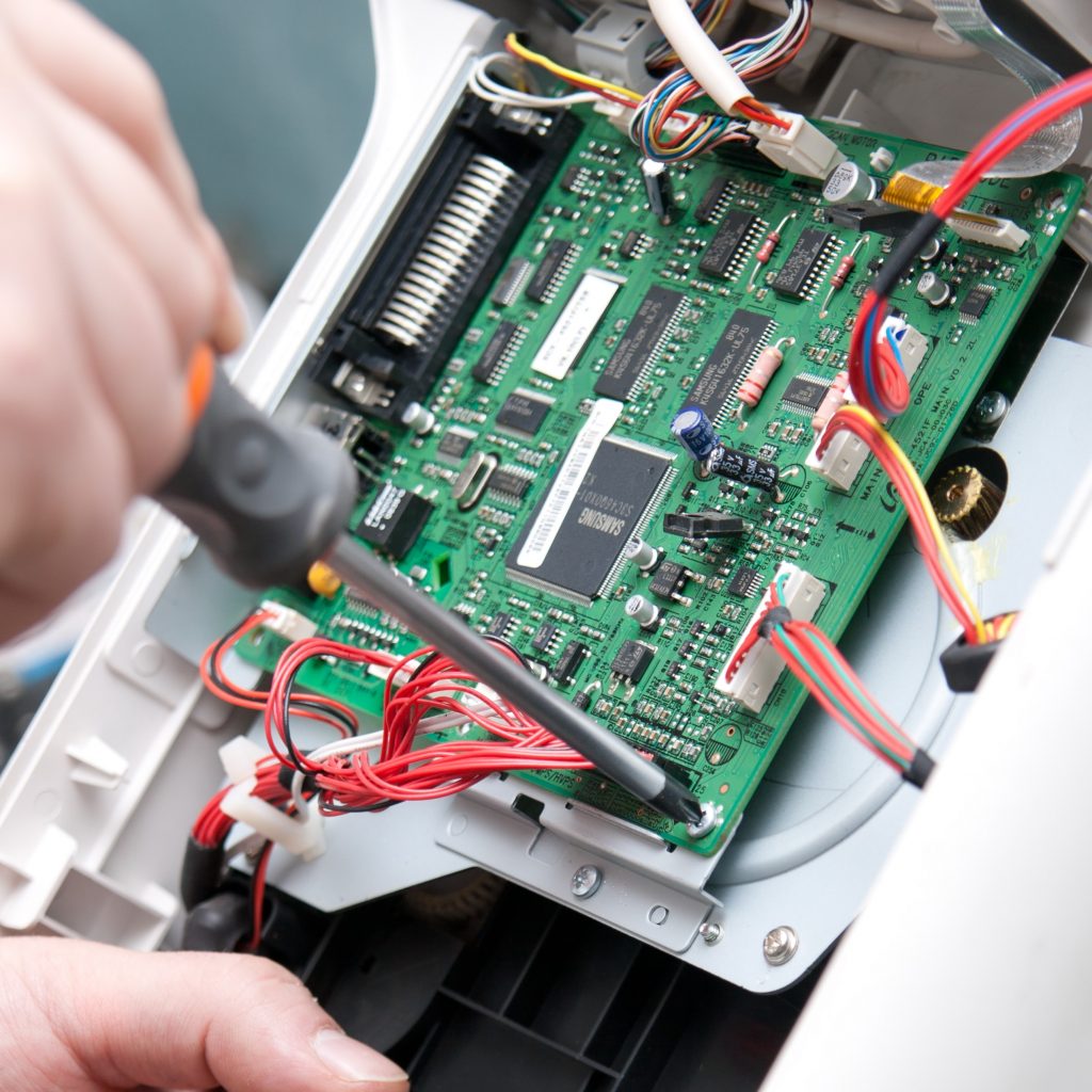 Electronics manufacturer box-build assembly screwing populated pcb into assembly